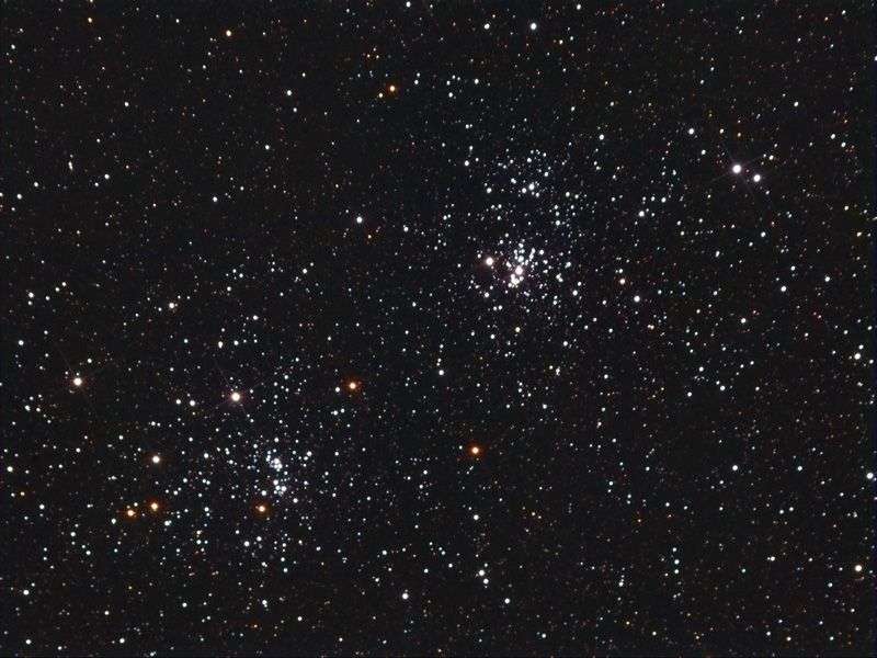 Two rich open star clusters side by side in a dense star field