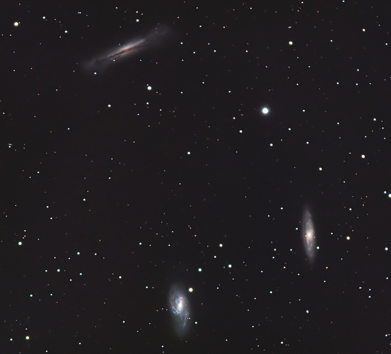 Three spiral galaxies in one field: one edge-on at top left and two tilted spirals at right and bottom