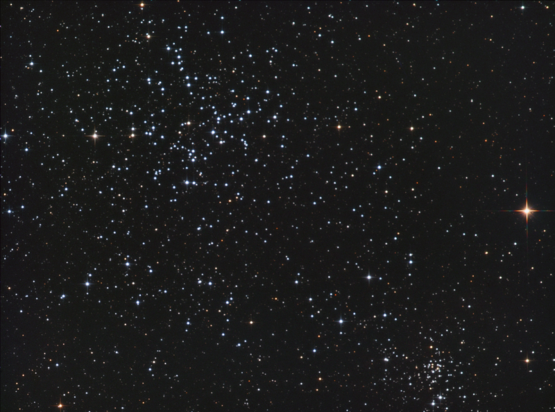 Scattered open cluster of bright blue-white stars filling the upper part of the frame
