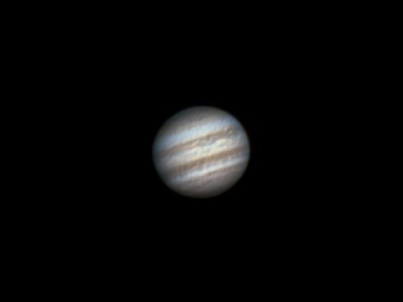 Jupiter showing its cloud belts against a black background